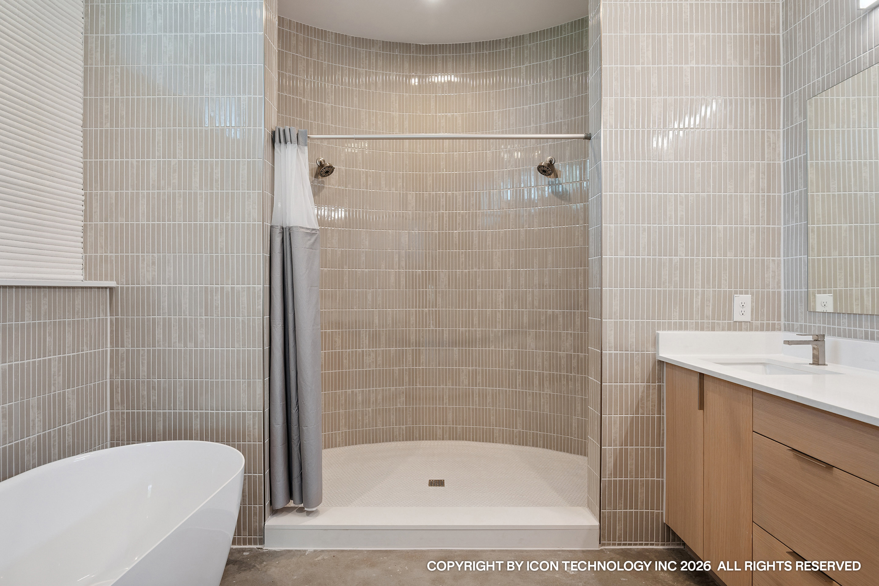Curved tiled bathroom with shower and soaking tub